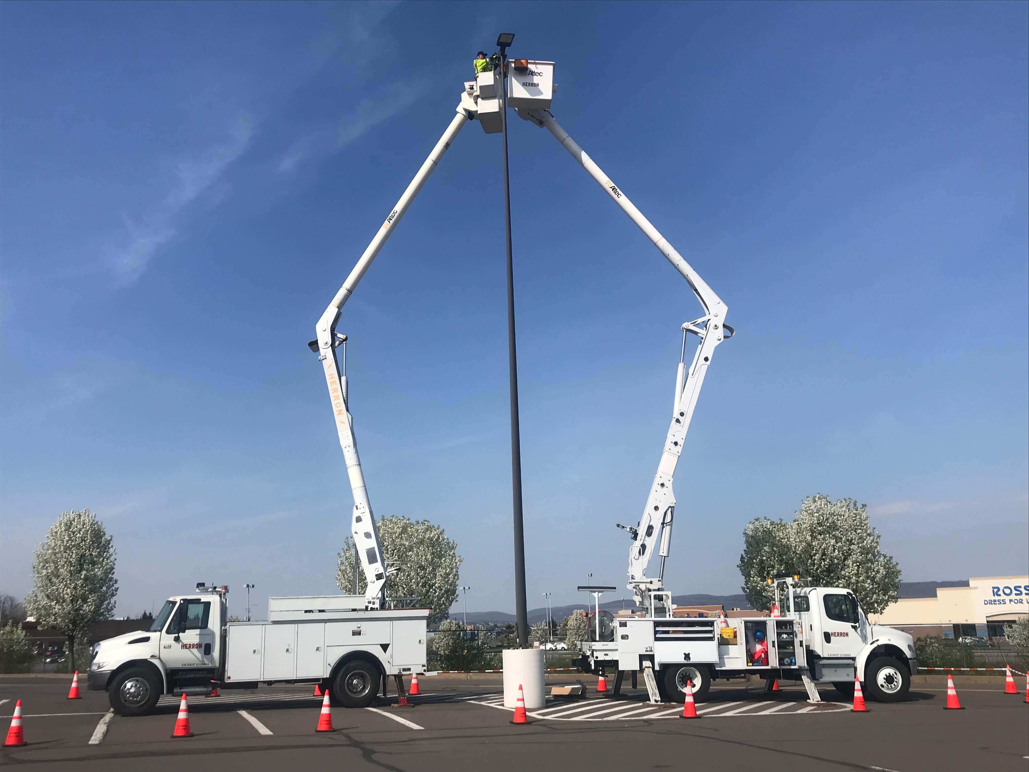 Bucket trucks at an install site