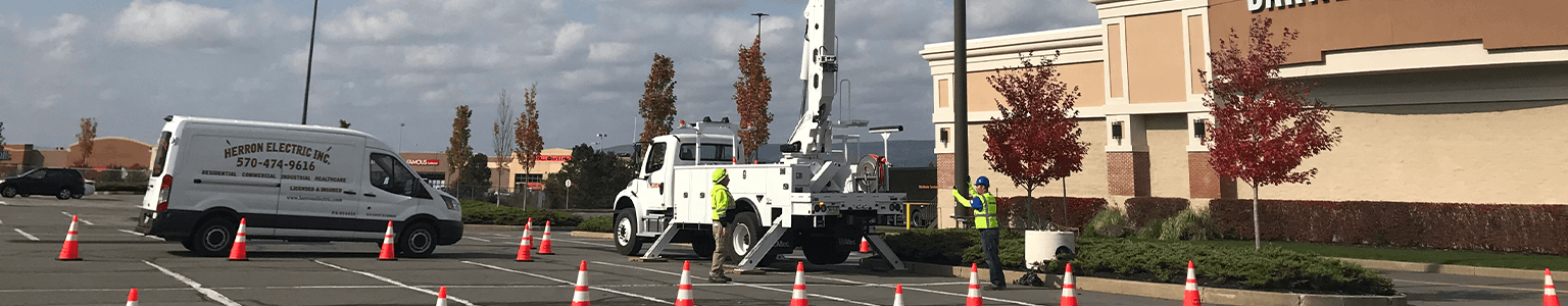 Herron Electric trucks working on a lamppost